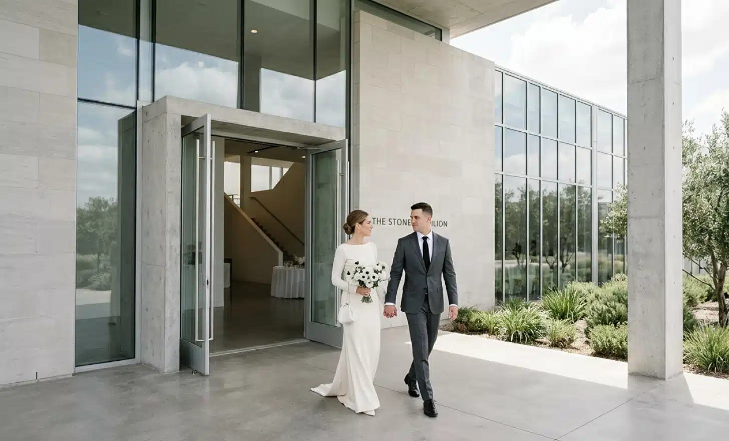 Couple entering a modern minimalist venue, illustrating how privacy is shaping wedding planning in 2026.