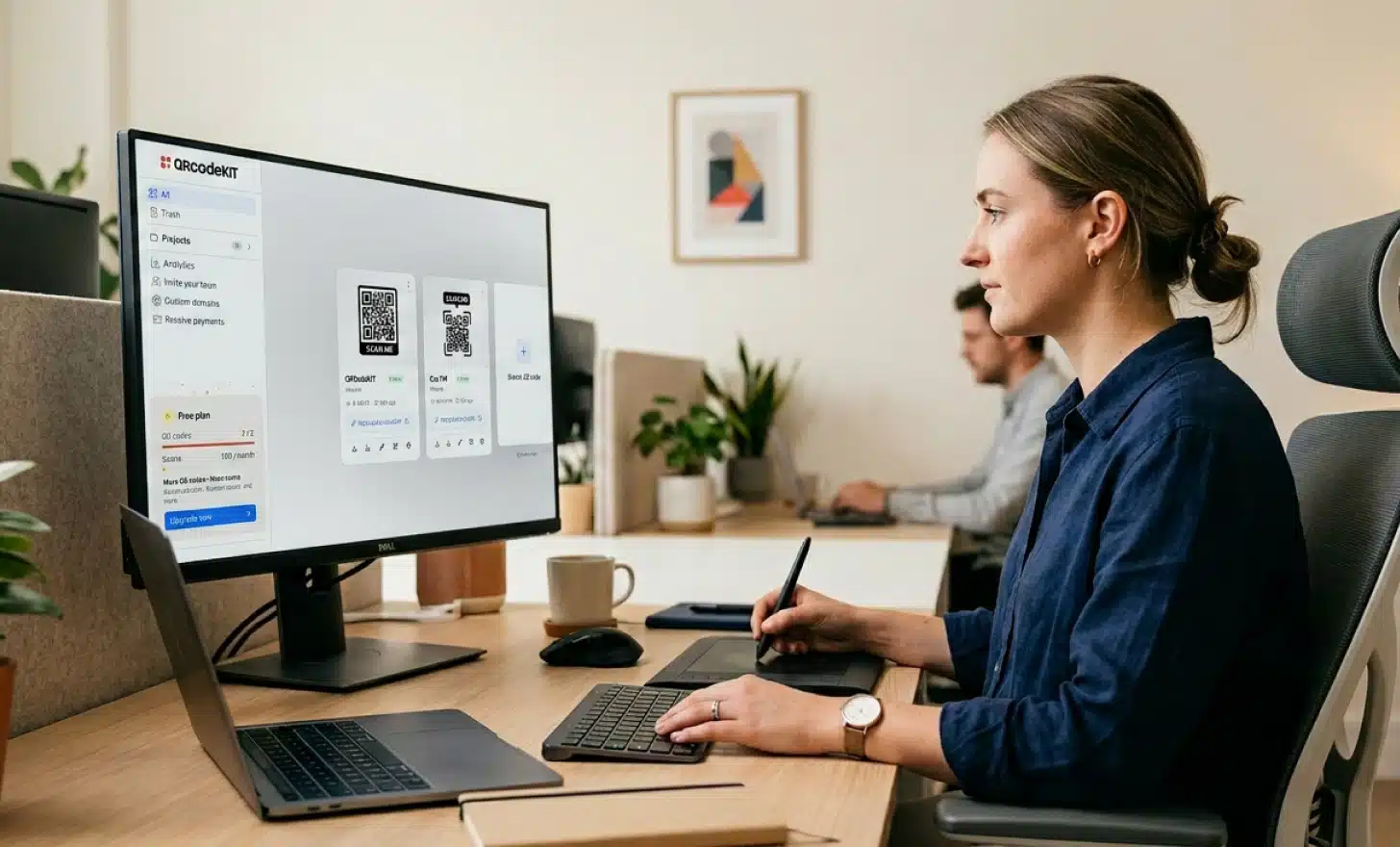 Designer working on a desktop computer creating a custom branded QR code with brand colors on screen.