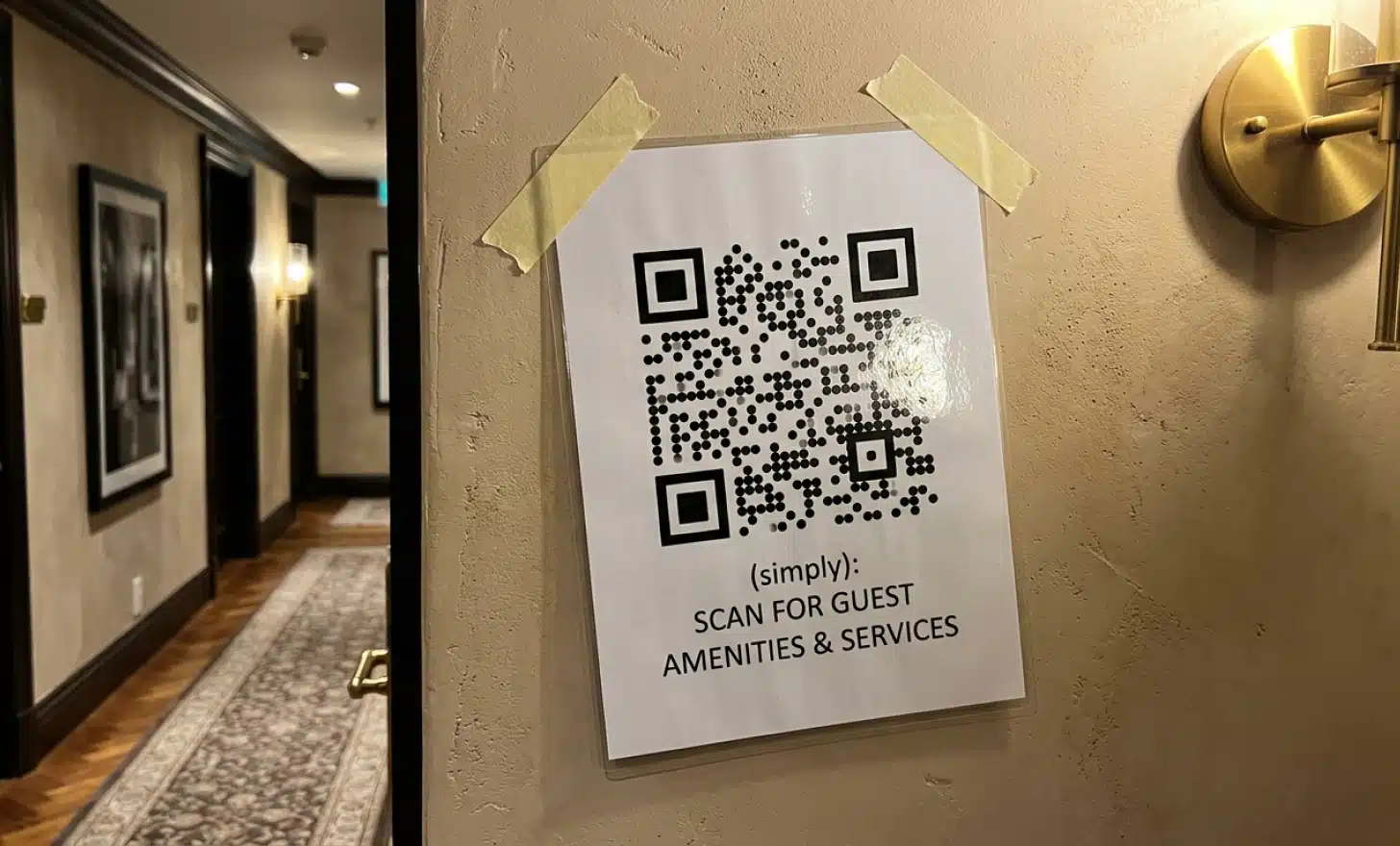 Generic laminated QR code sign clashing with an elegant boutique hotel interior