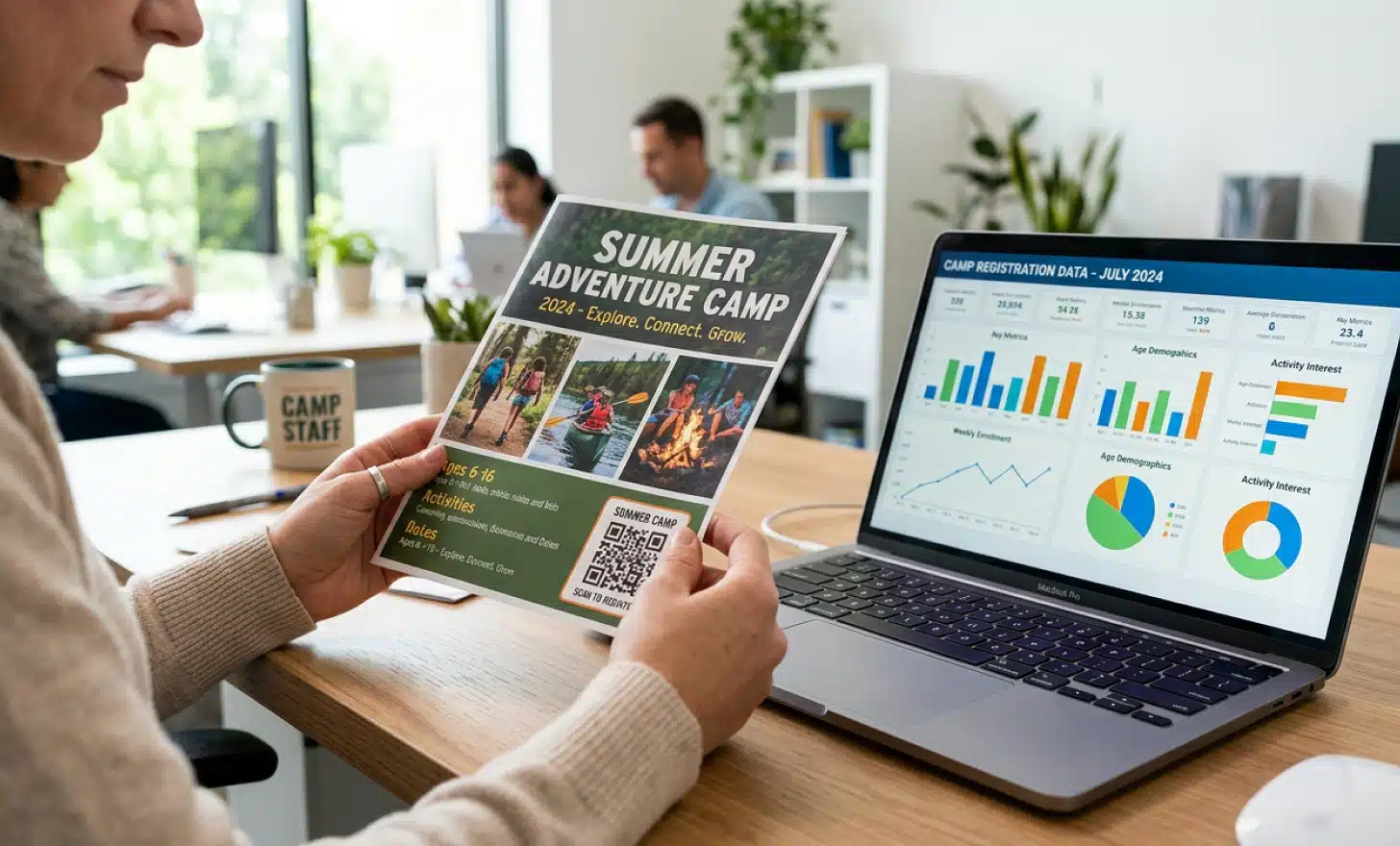Hands holding a camp brochure with a QR code next to a laptop displaying analytics charts.