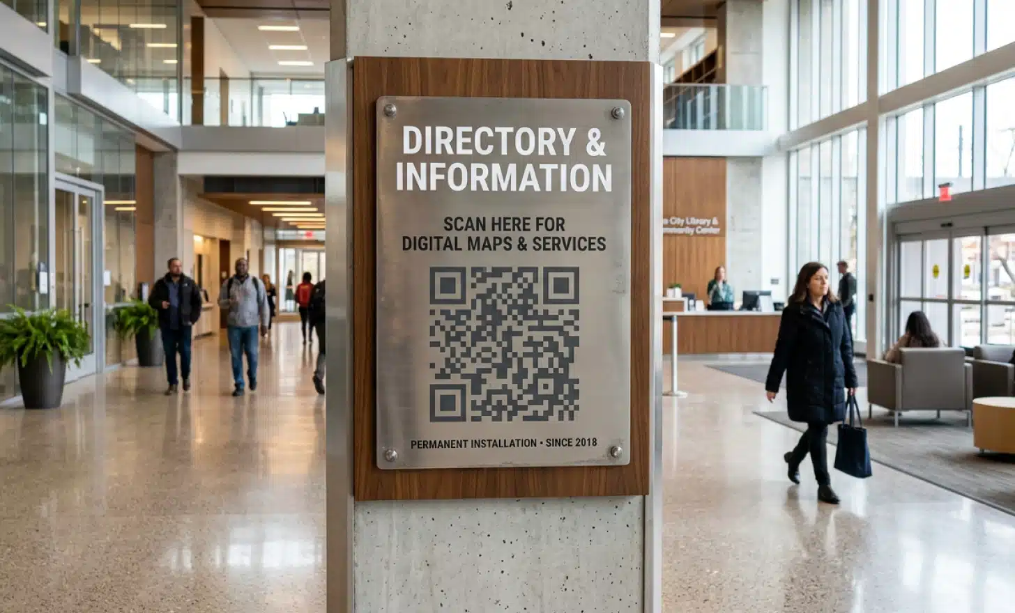 Permanent QR code panel on a wayfinding sign in a modern lobby, suggesting long-term reliability.